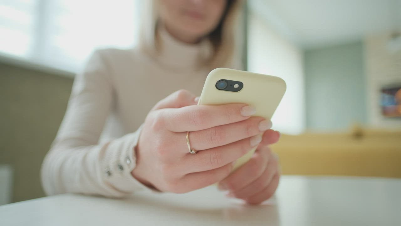 A close-up of someone checking a message on their phone