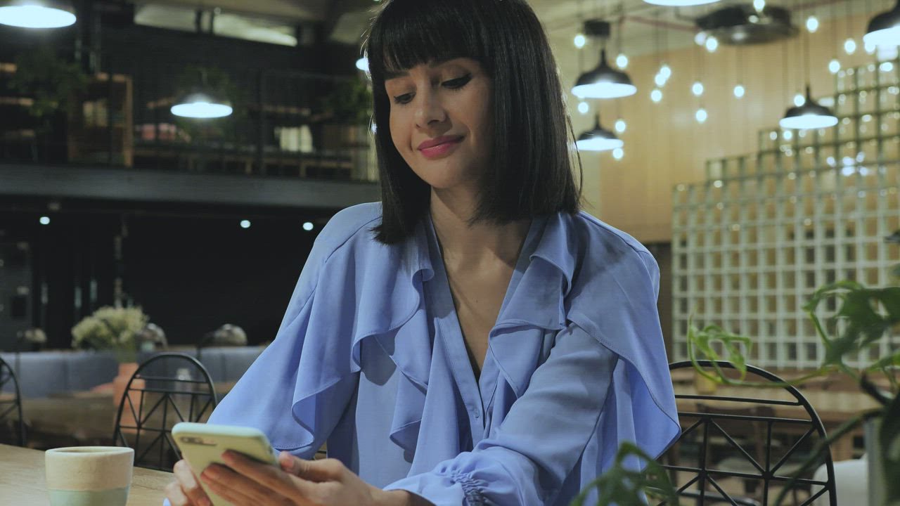 A woman reading an email on her phone