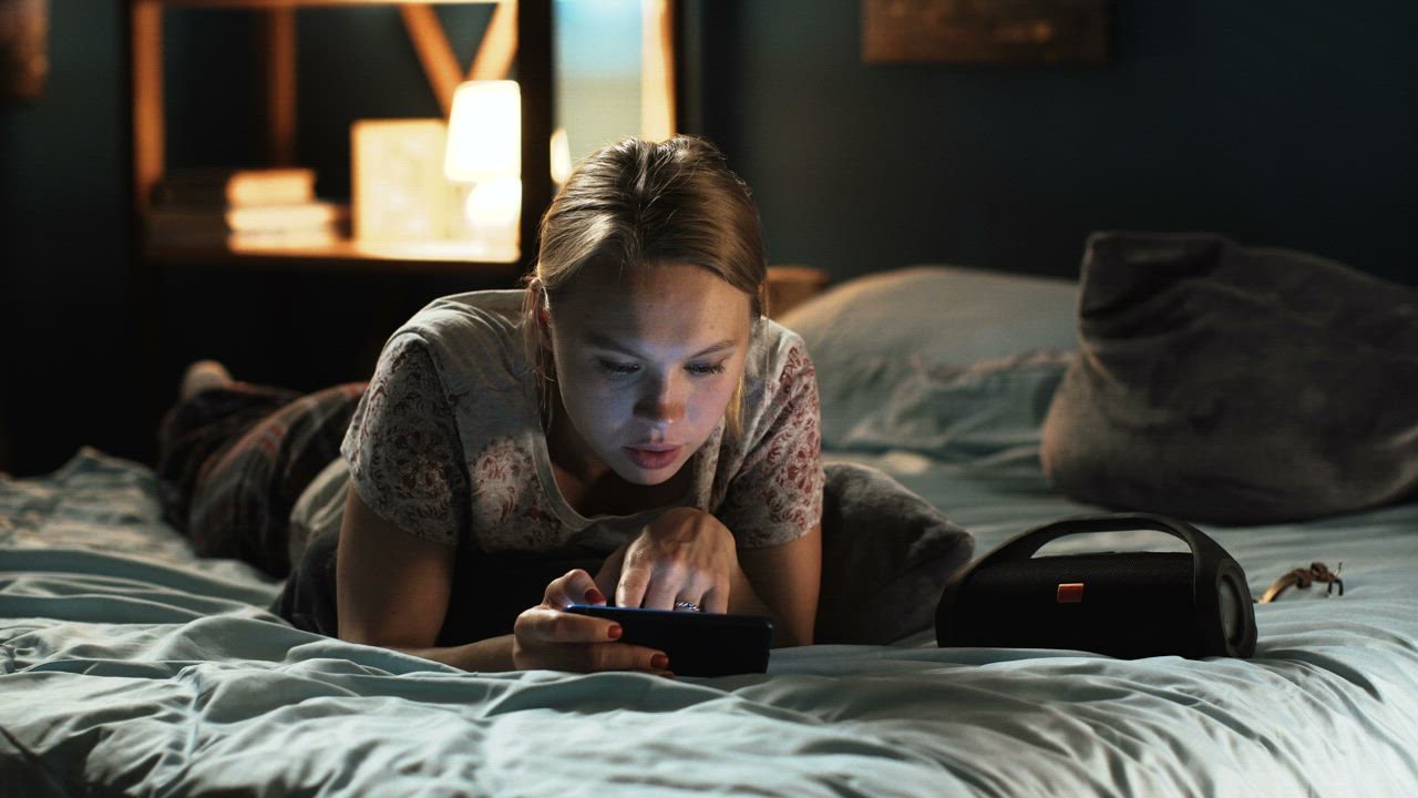 Someone reading a message on their phone late at night
